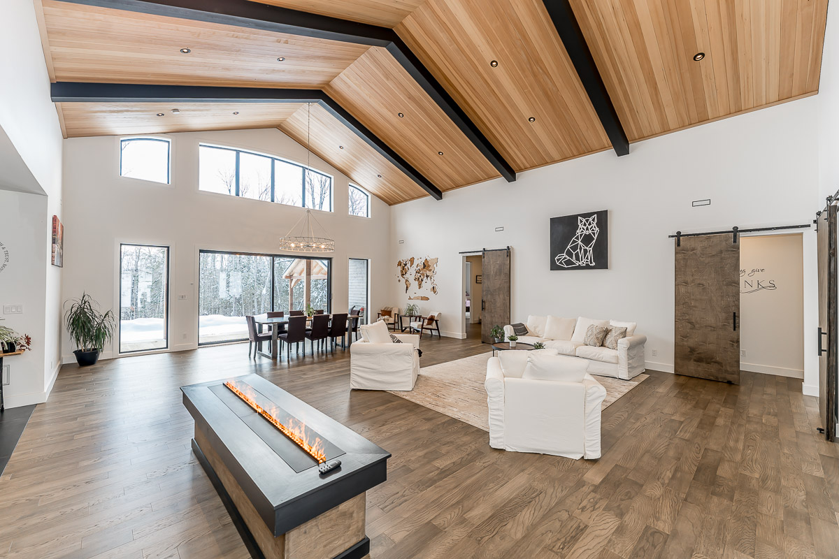 interior room, high ceiling, wood beams, open layout