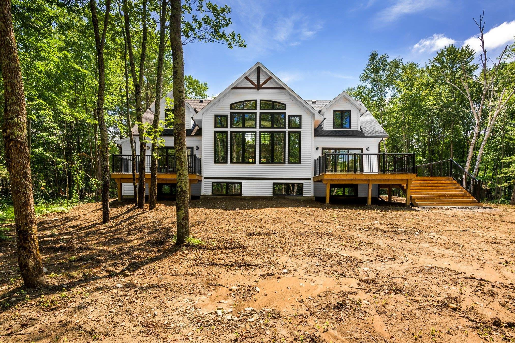 exterior home, dual decks, two decks, large windows, white house, home